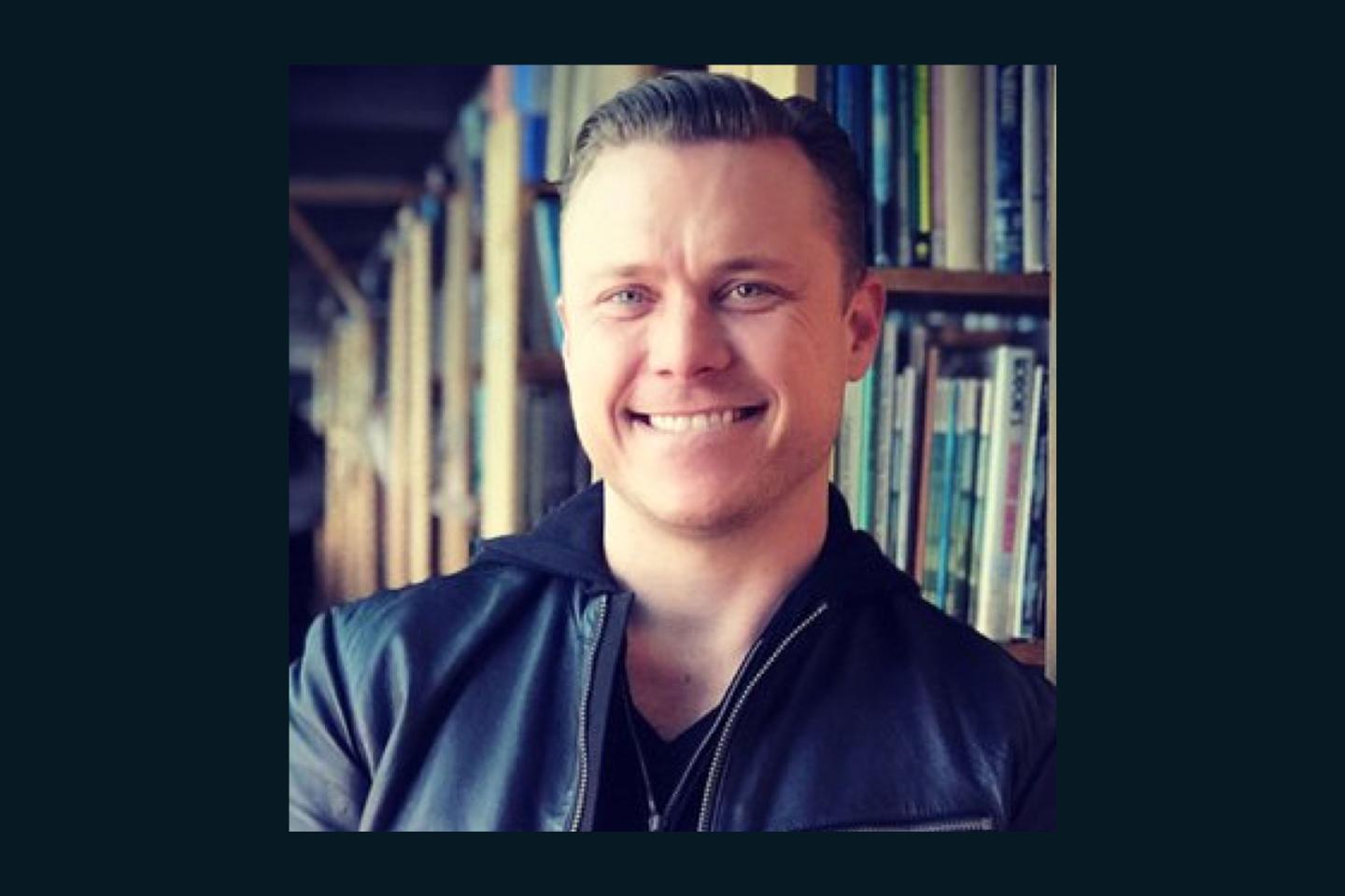 A portrait of Bob Lee in front of a bookcase