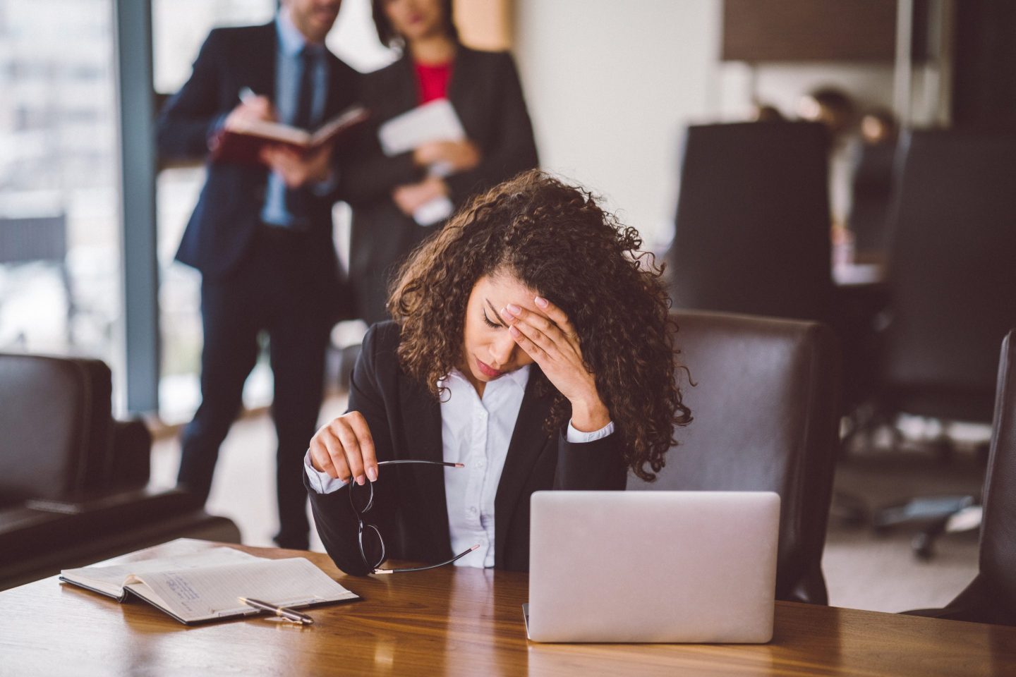 A worried-looking woman at a desk.