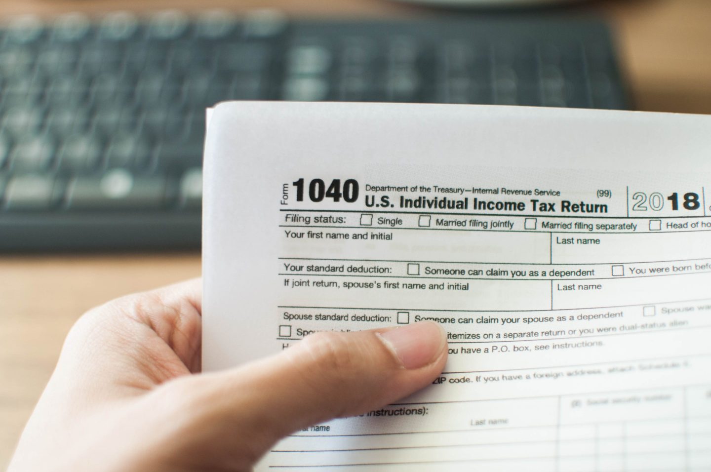 A close-up view of a man holding a tax form
