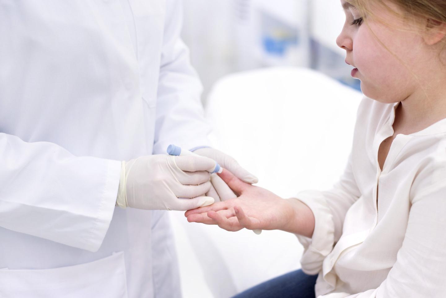 3 former executives are accused of hiding faulty medical tests that produced false results for tens of thousands of children