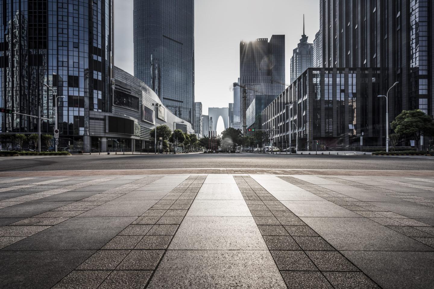 Photo of pavement and commercial properties.