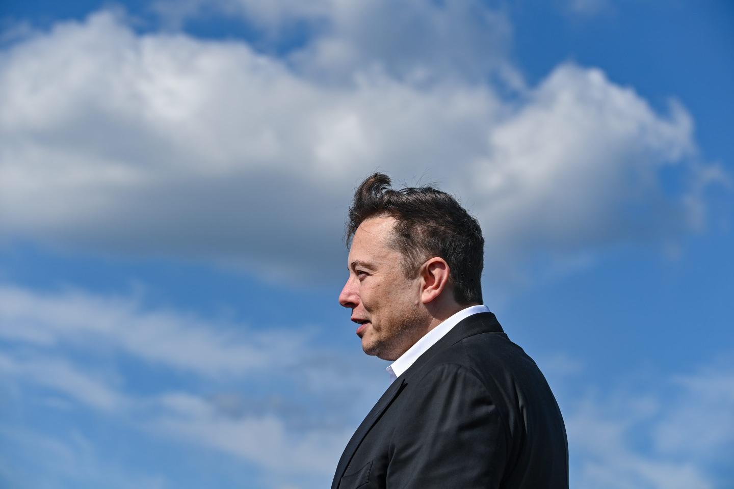 Elon Musk, Twitter and Tesla CEO, stands against a sunny sky