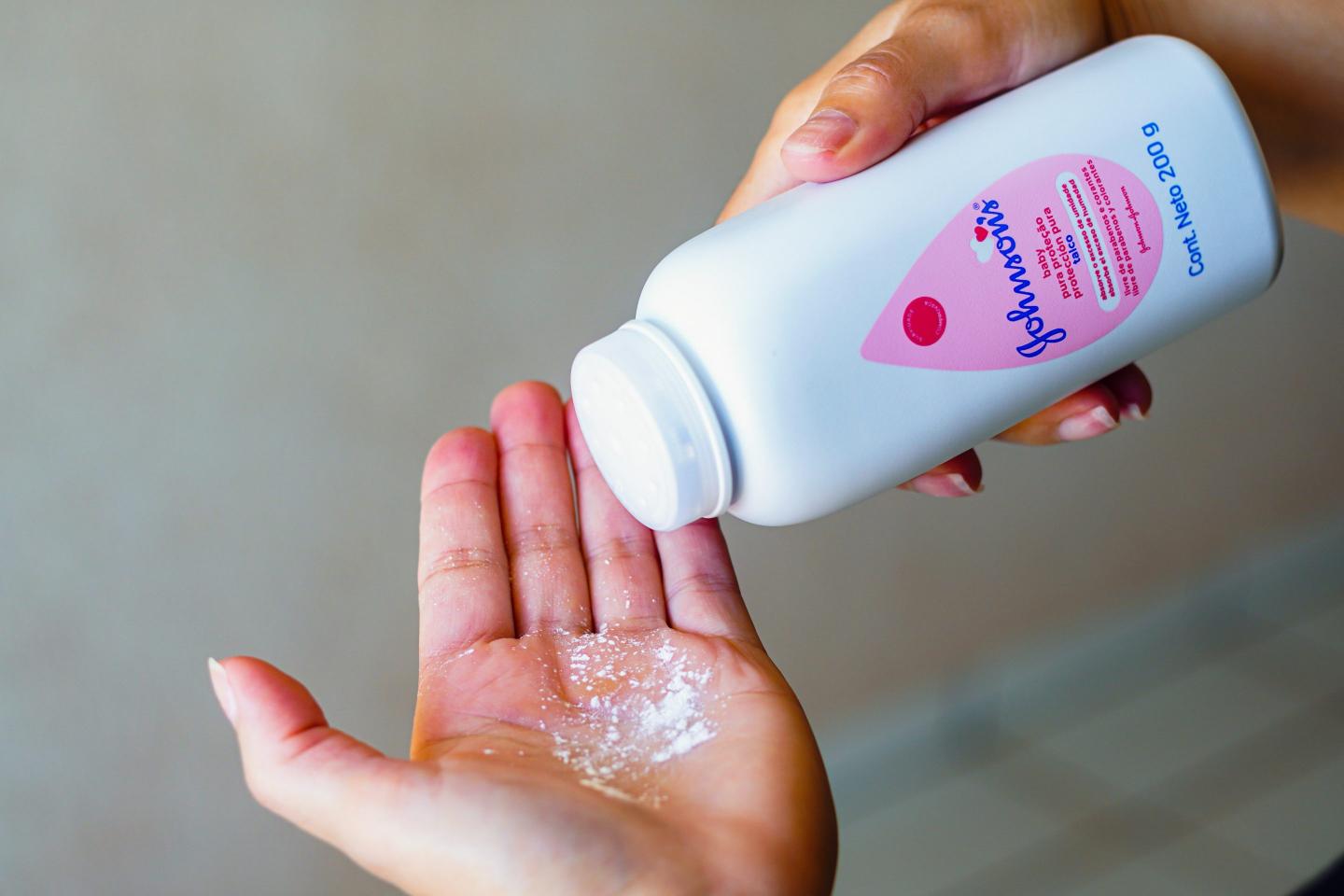 a person uses Johnson & Johnson baby powder.