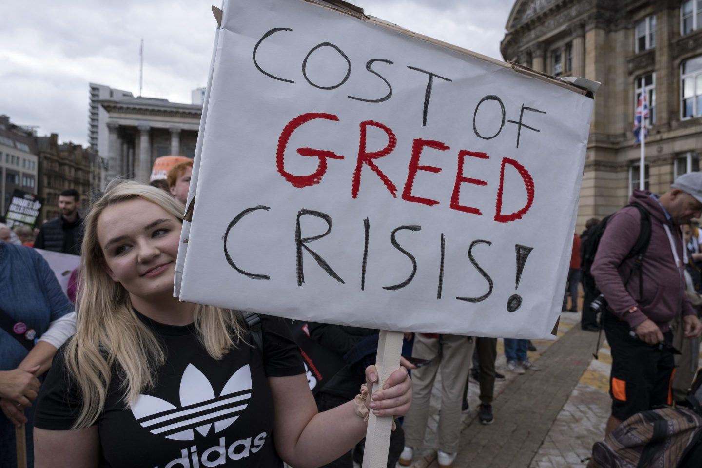 A protestor holds up a sign at The People's Assembly Against Austerity protest on 2nd October 2022 in Birmingham, United Kingdom.