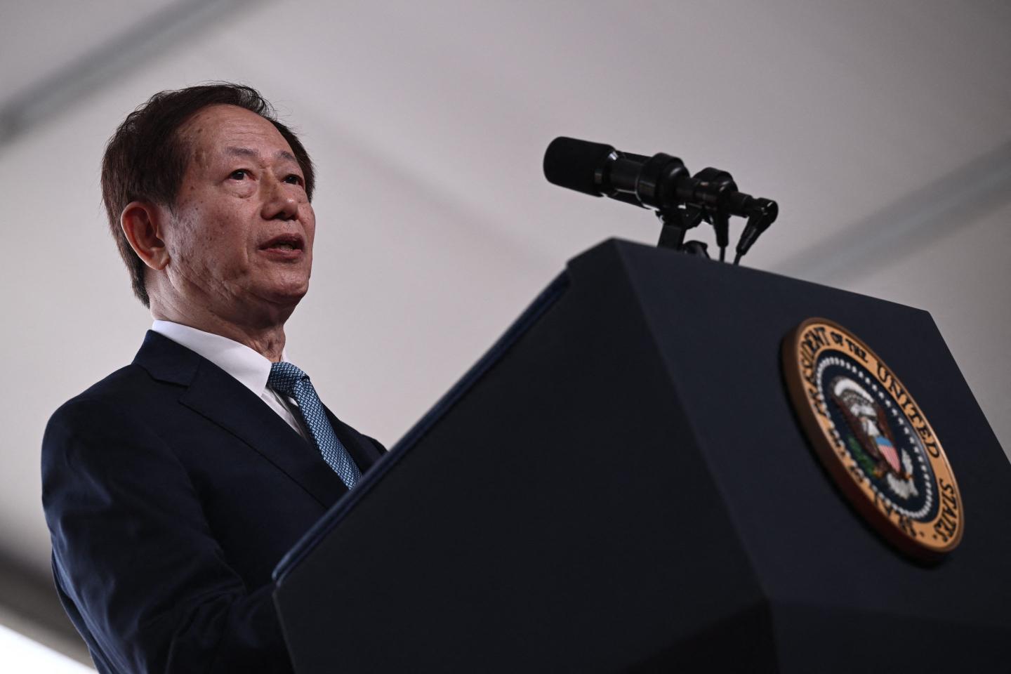 TSMC Chairman Mark Liu speaks behind a podium