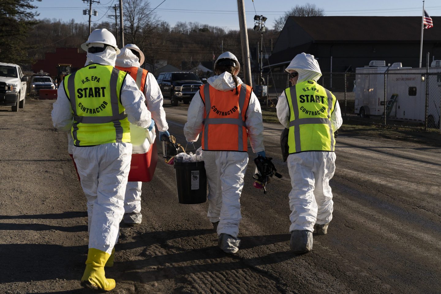 EPA contractors walk with collected soil samples from the Norfolk Southern train derailment site on March 9, 2023 in East Palestine, Ohio.