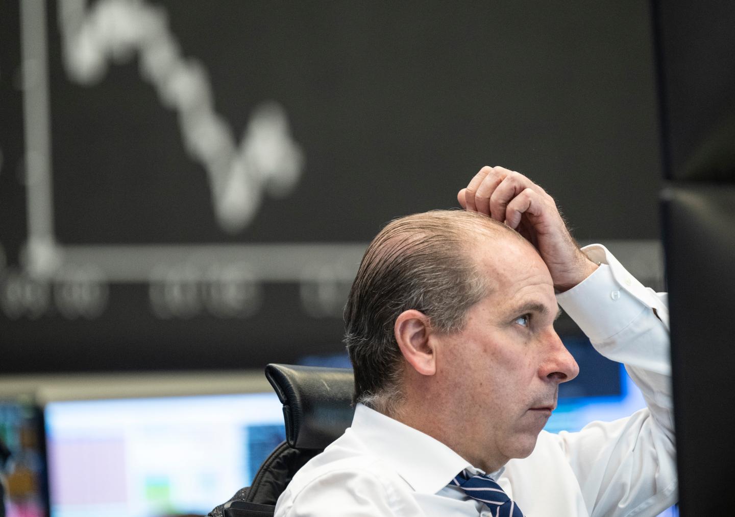 A man looks worriedly at a screen