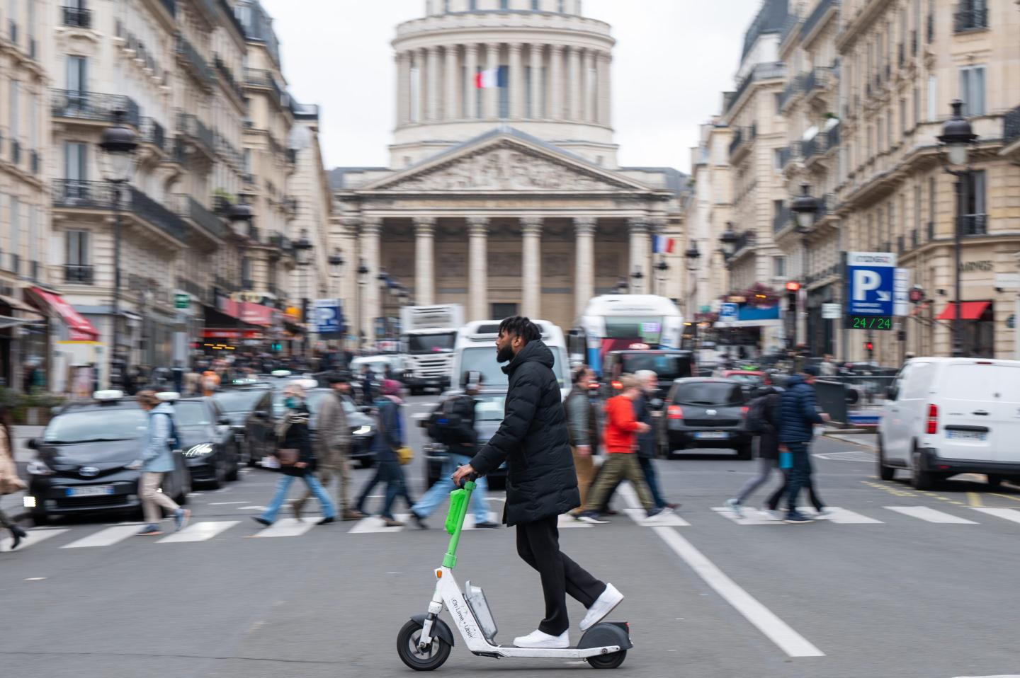 A rider on a public hire electric scooter, operated by Lime Technologies AB, in Paris
