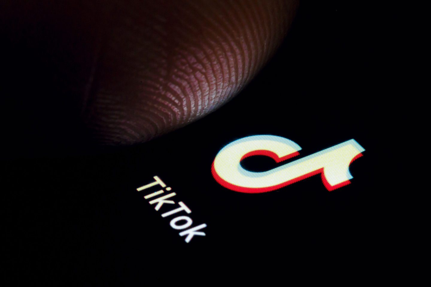 The TikTok app is displayed on a smartphone