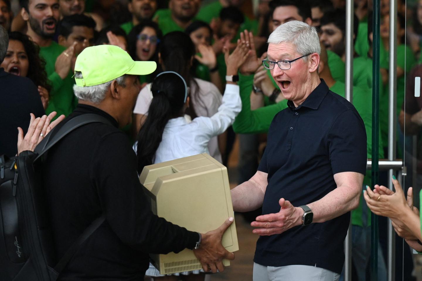 Apple CEO Tim Cook greets a customer in the company's new Mumbai store.