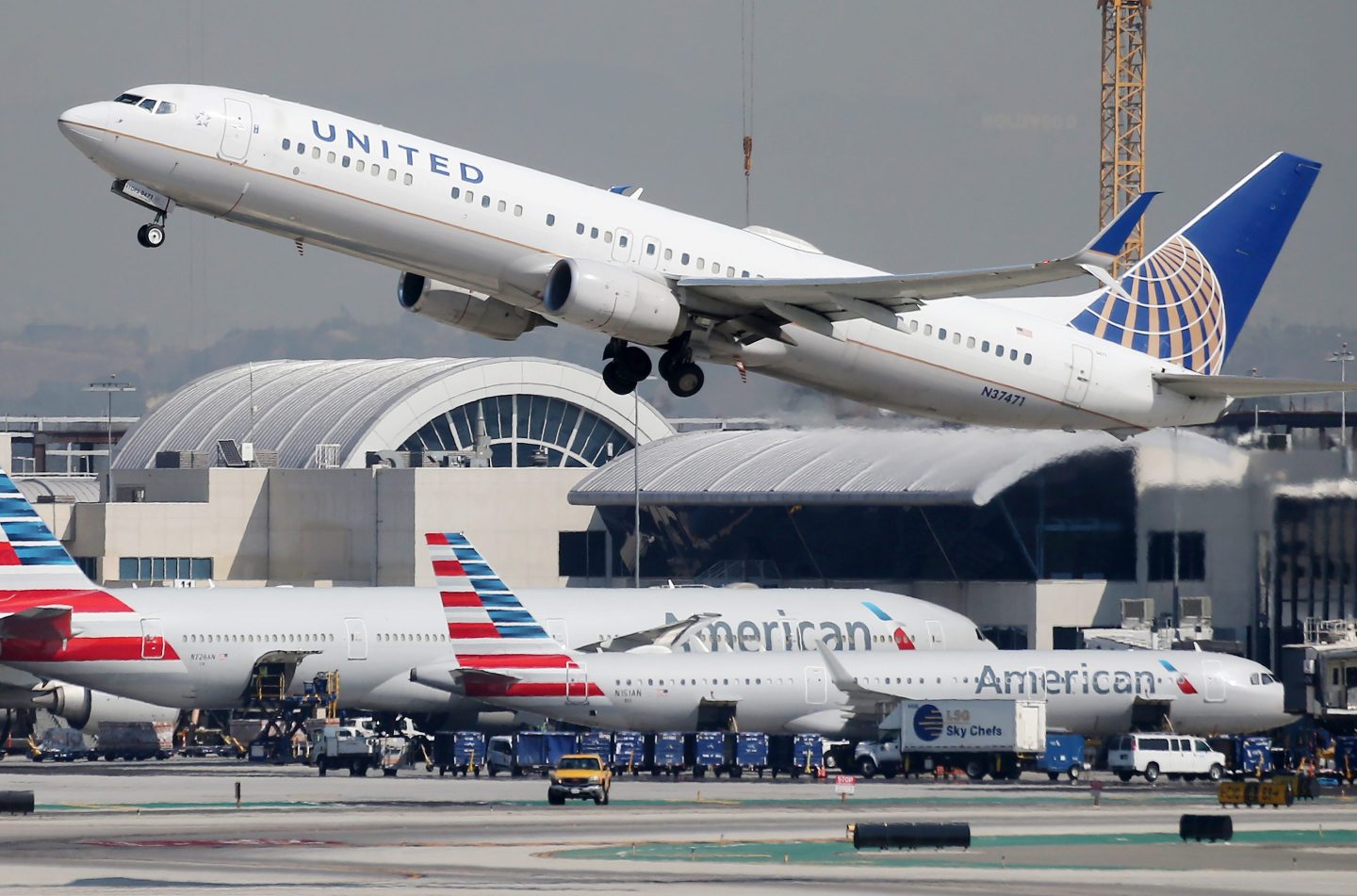 A United Airlines plane takes off above American Airlines planes on the tarmac at Los Angeles International Airport (LAX) on October 1, 2020 in Los Angeles, California.