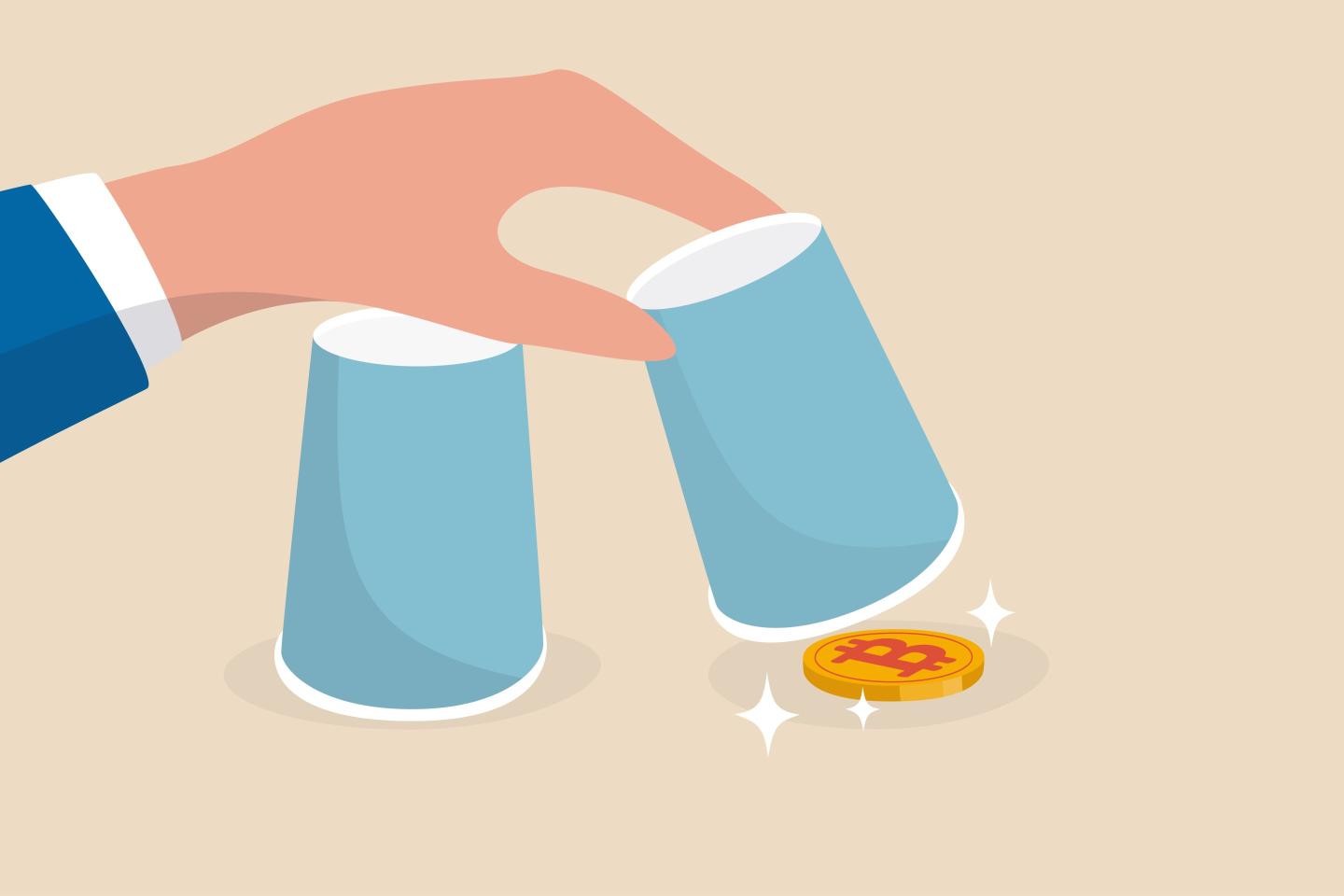Bitcoin hidden under cup