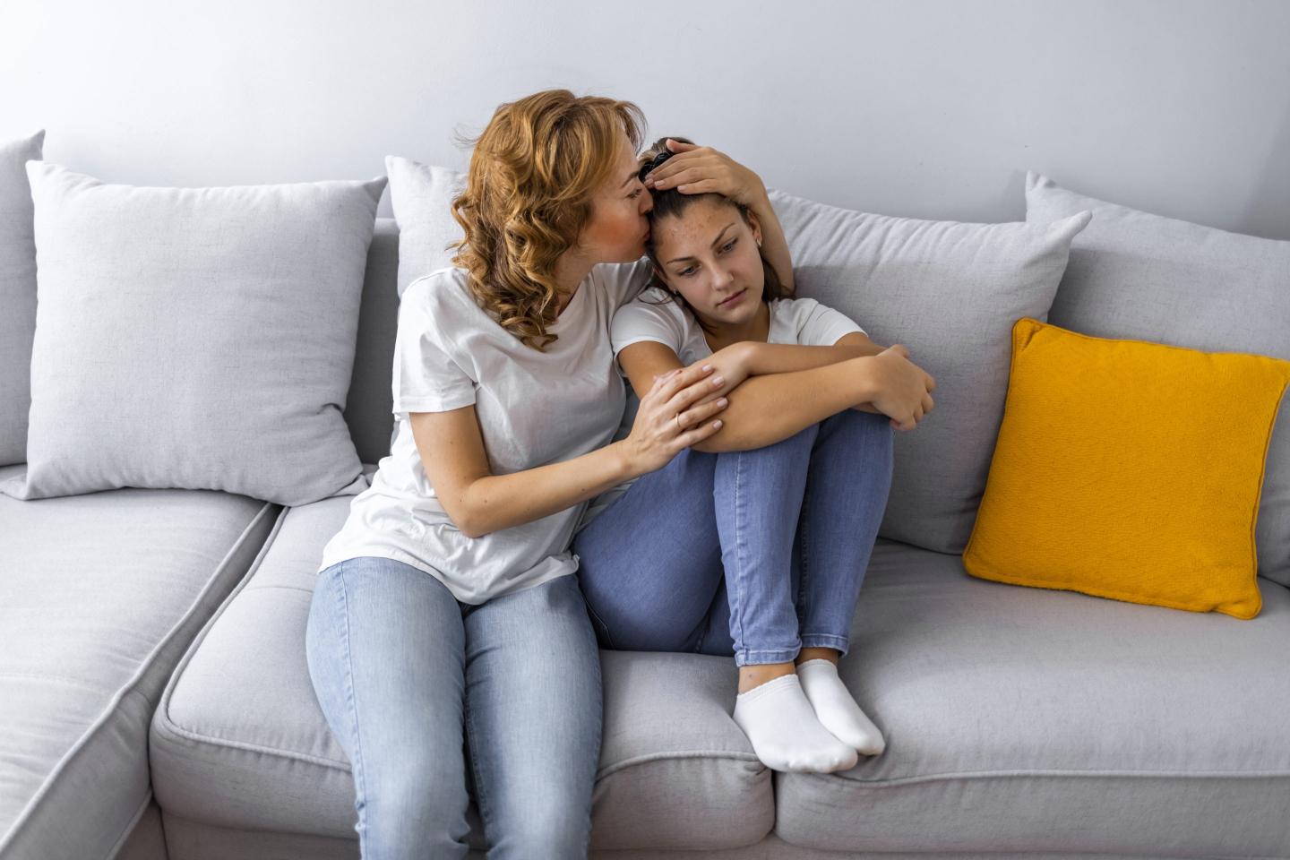 Mother comforting daughter