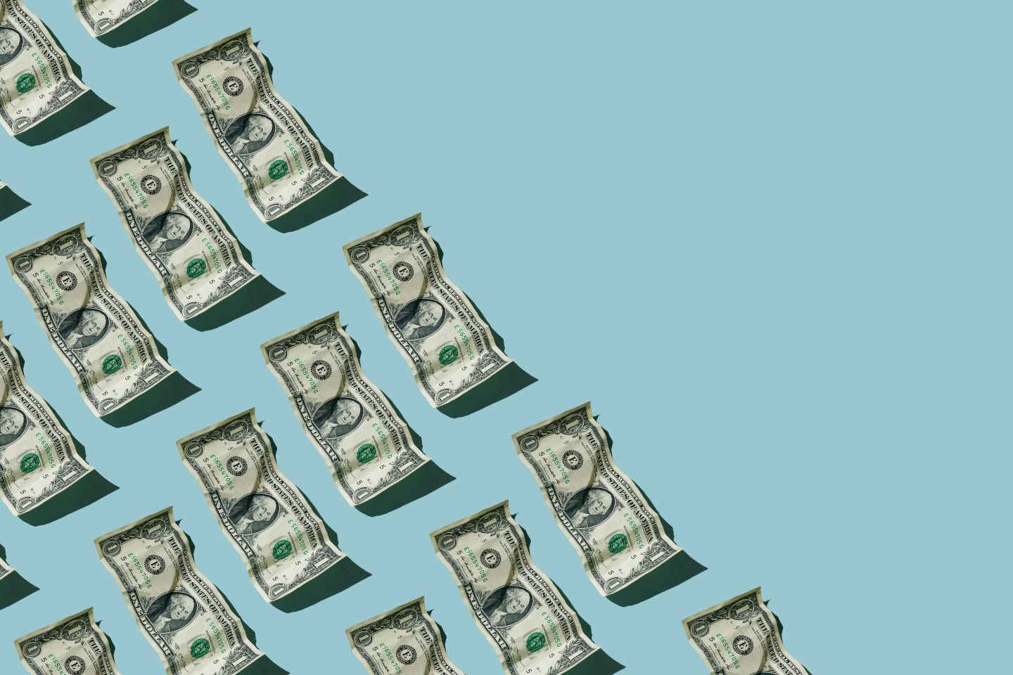 Crumpled one dollar bills on blue background