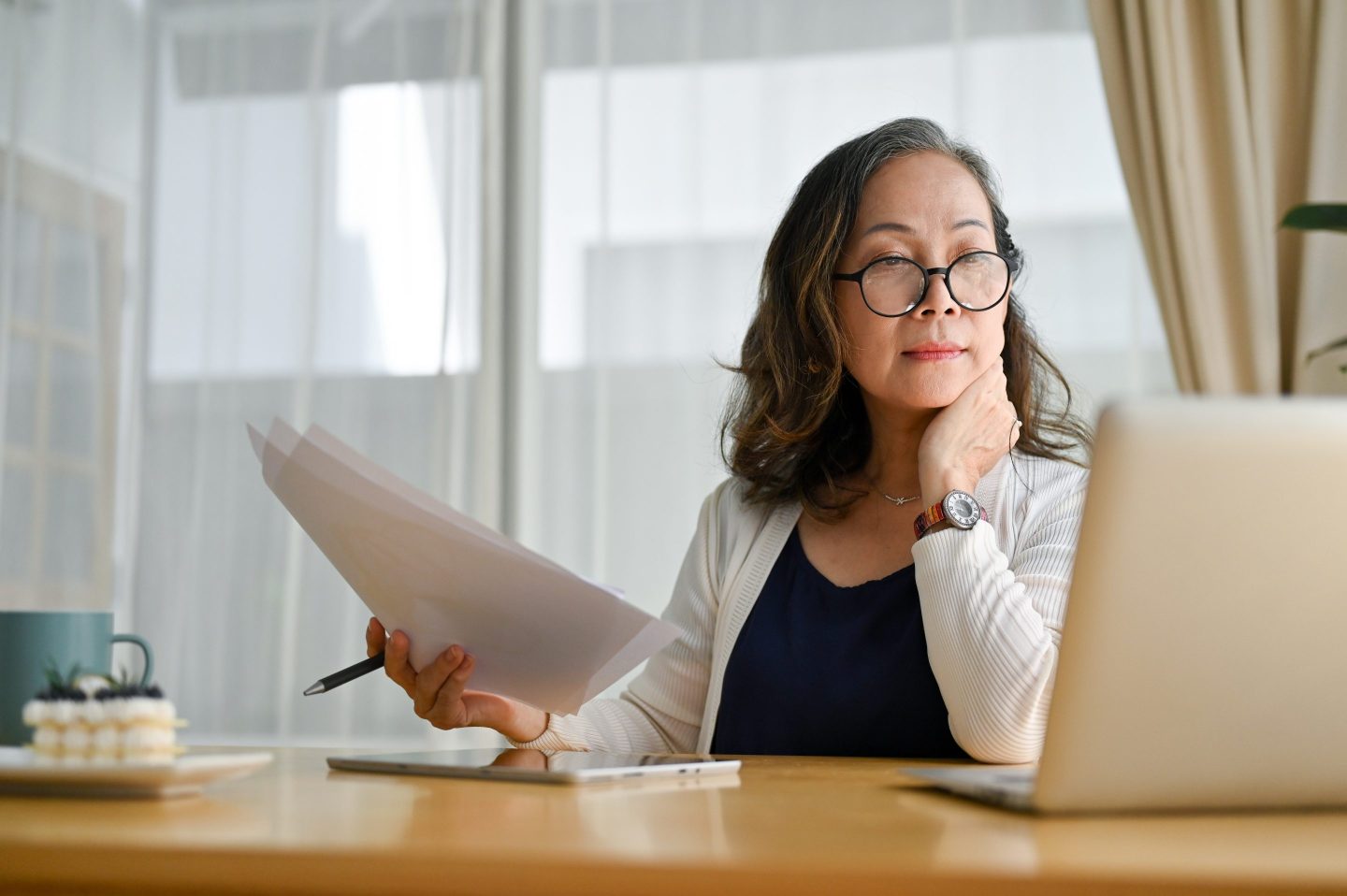 Concentrated asian middle aged female businesswoman using portable computer
