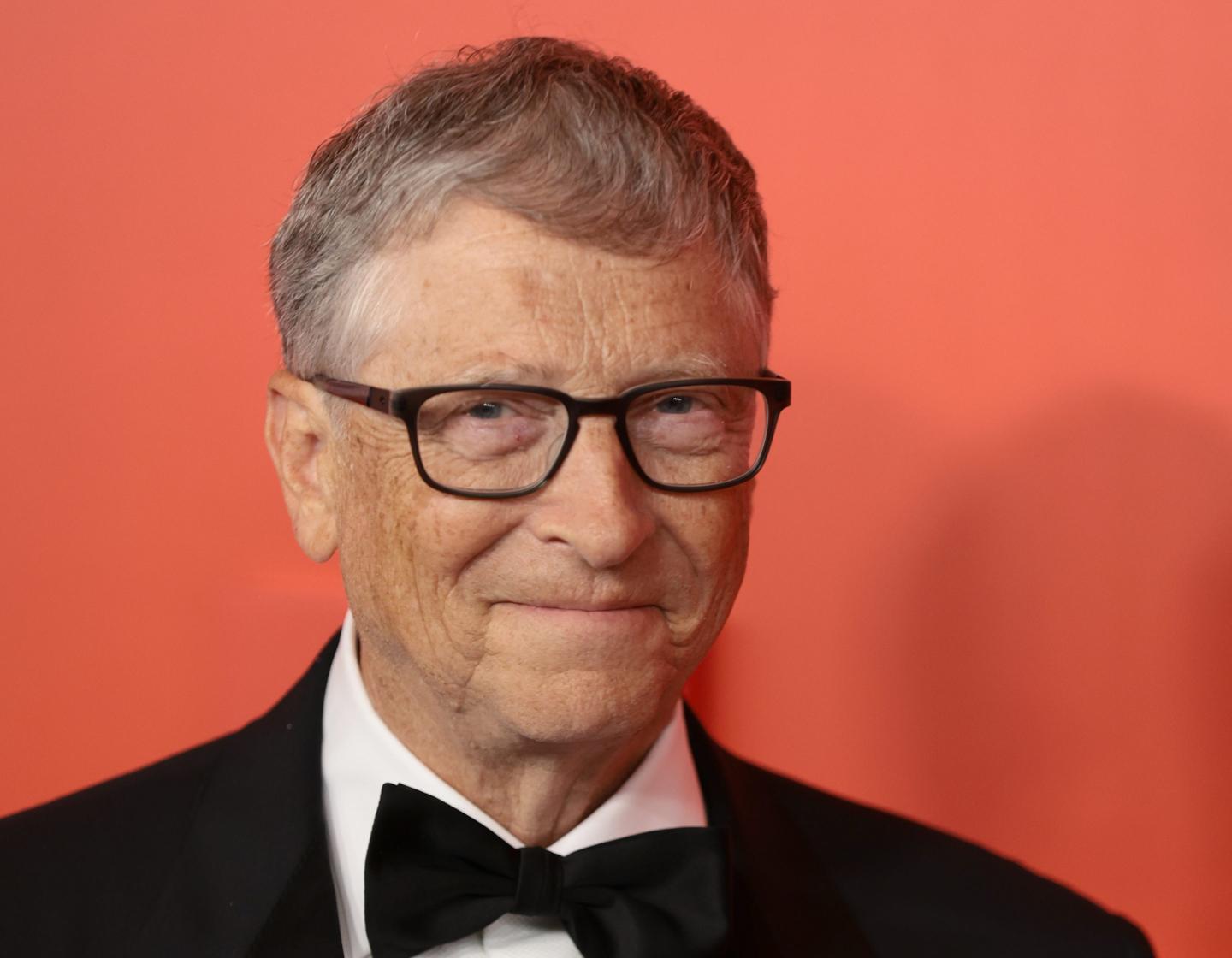 Bill Gates, who founded Microsoft, smiling at a gala.