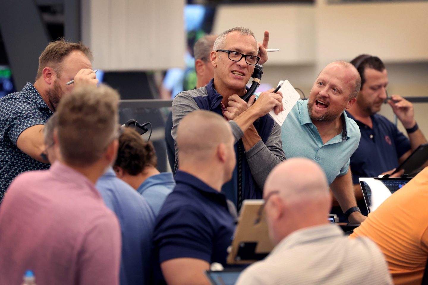 Traders signal offers in the options pit at the CBOE Global Markets exchange as the Federal Reserve announced it was raising interest rates on Sept. 21, 2022.