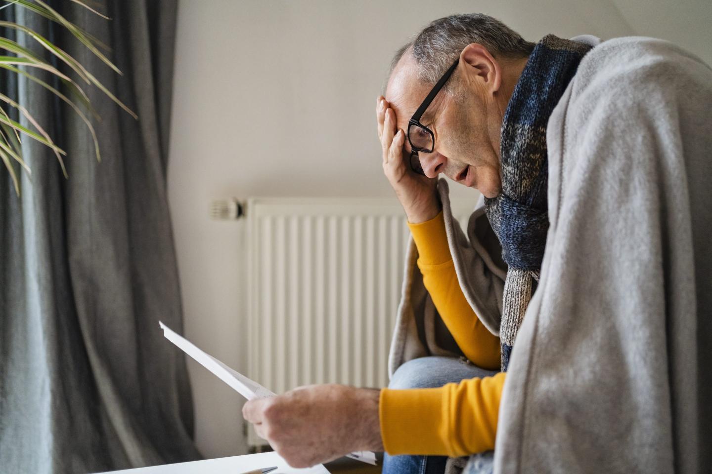 Worried man looking at a bill