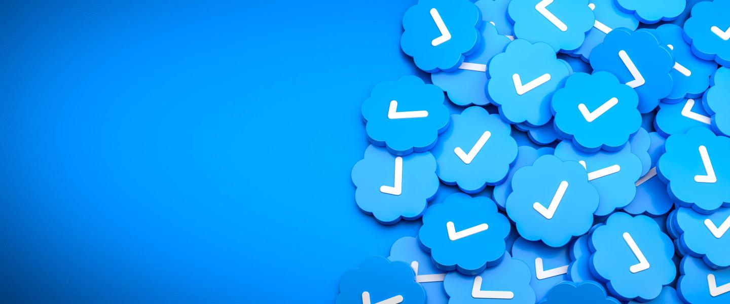 Blue check mark logos on a heap on a table.