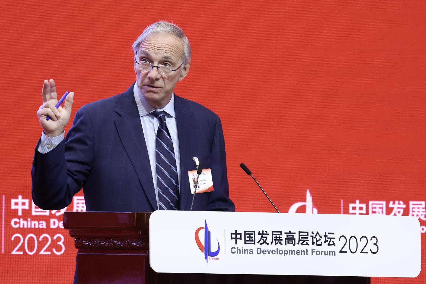Ray Dalio standing by a microphone