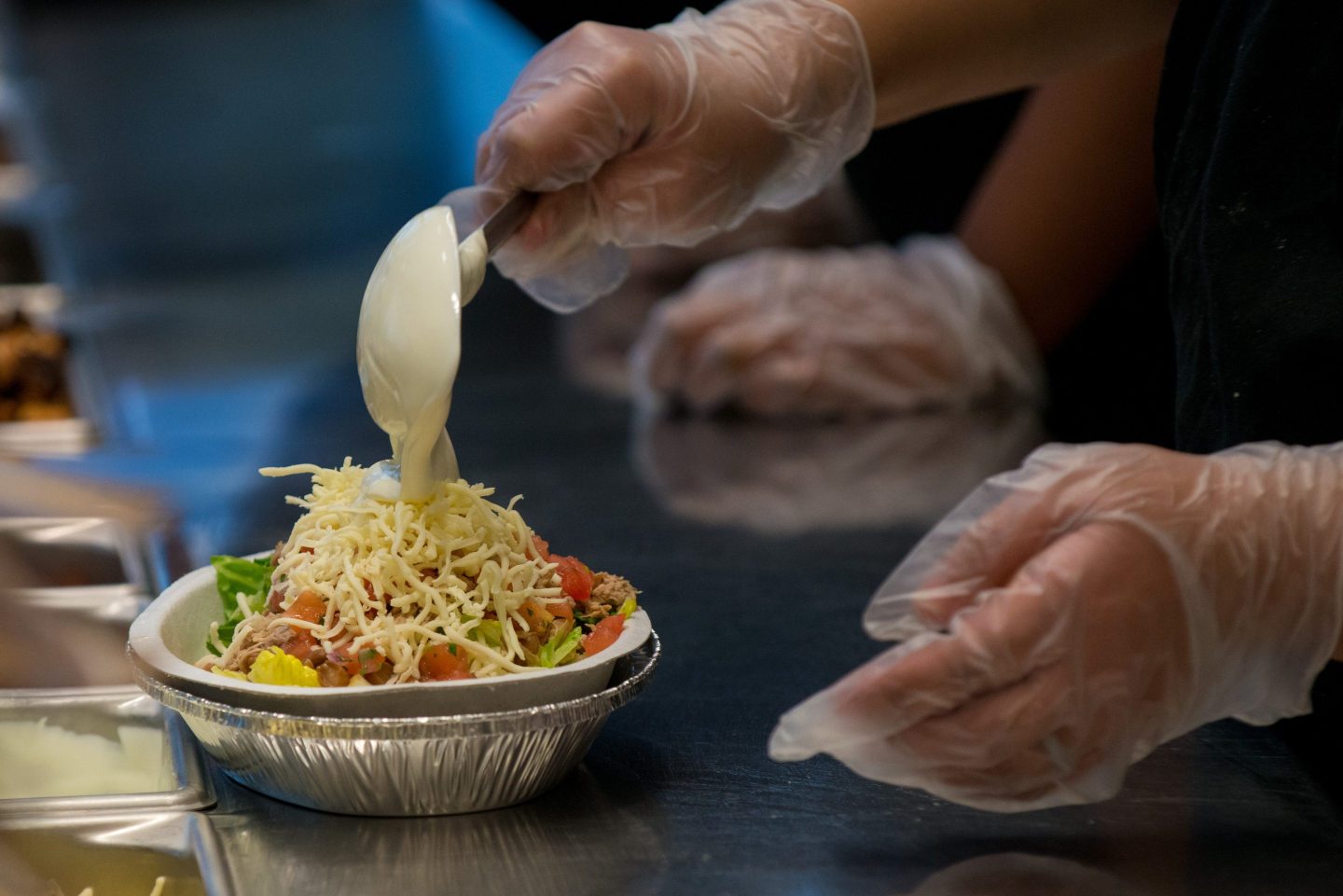 An employee prepares a lunch order at a Chipotle Mexican Grill restaurant at Madison Square Park in New York, U.S., on Wednesday, Jan. 29, 2014.