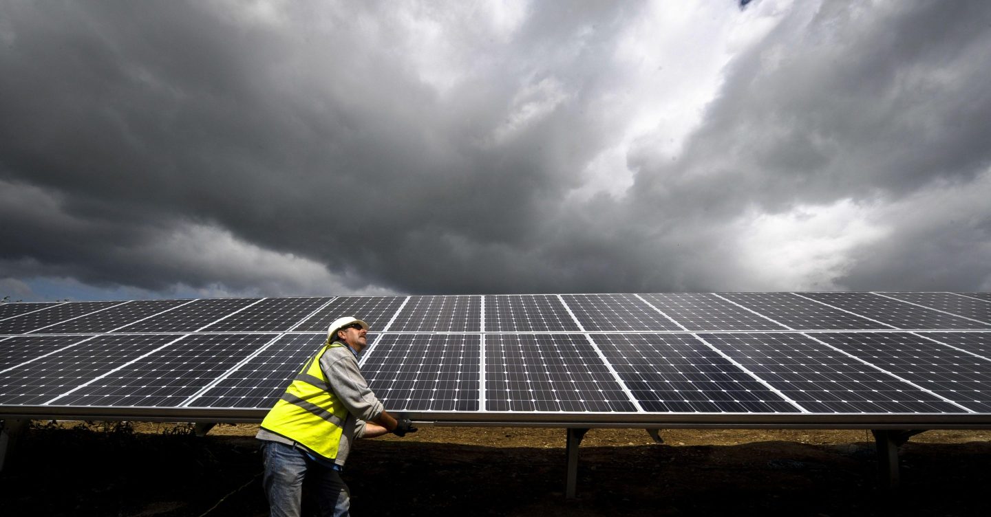 An engineer installing a solar panel in the U.K.