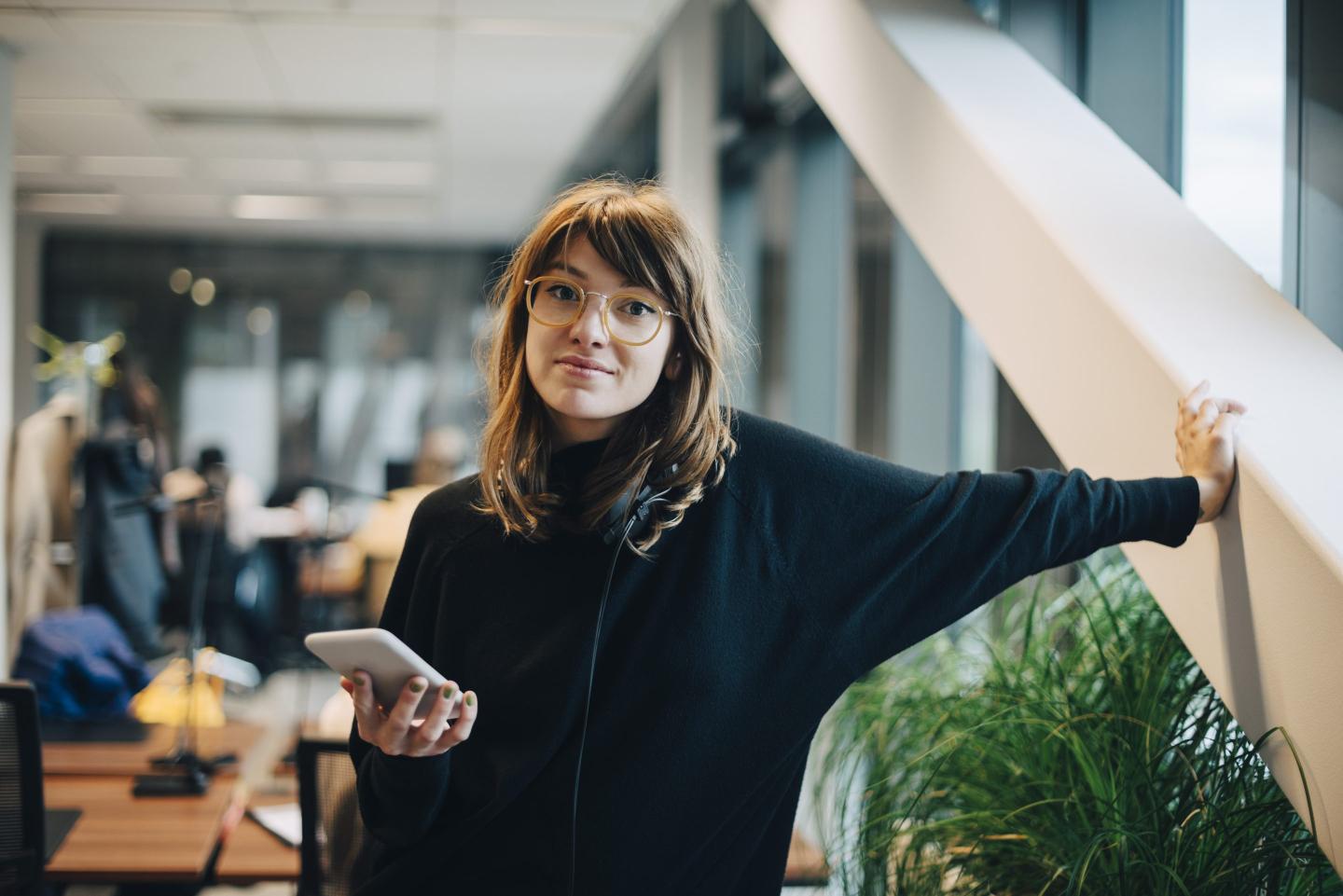 Gen Z woman on phone in office