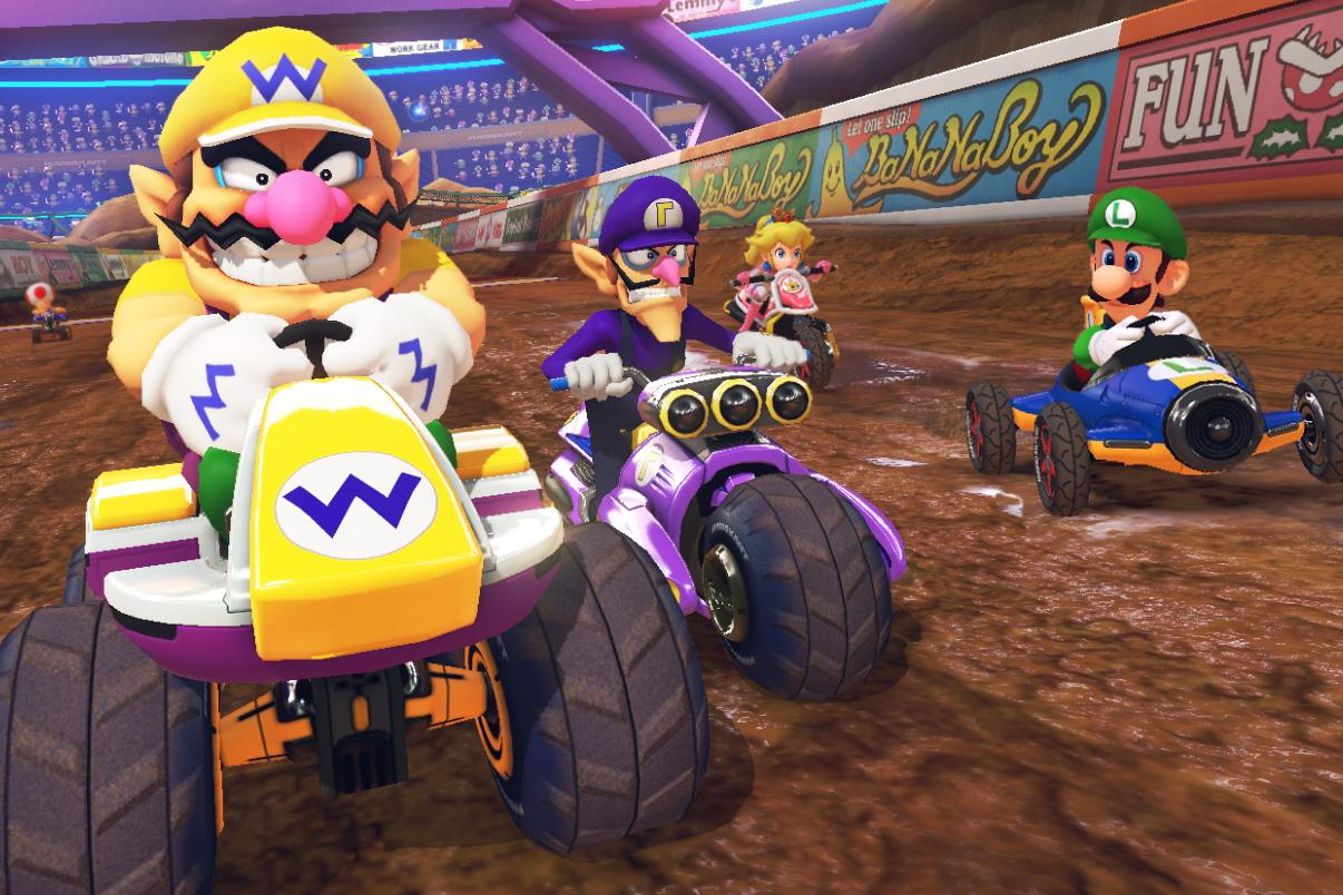 Waluigi racing with Wario, Peach and Luigi in Waluigi Stadium.