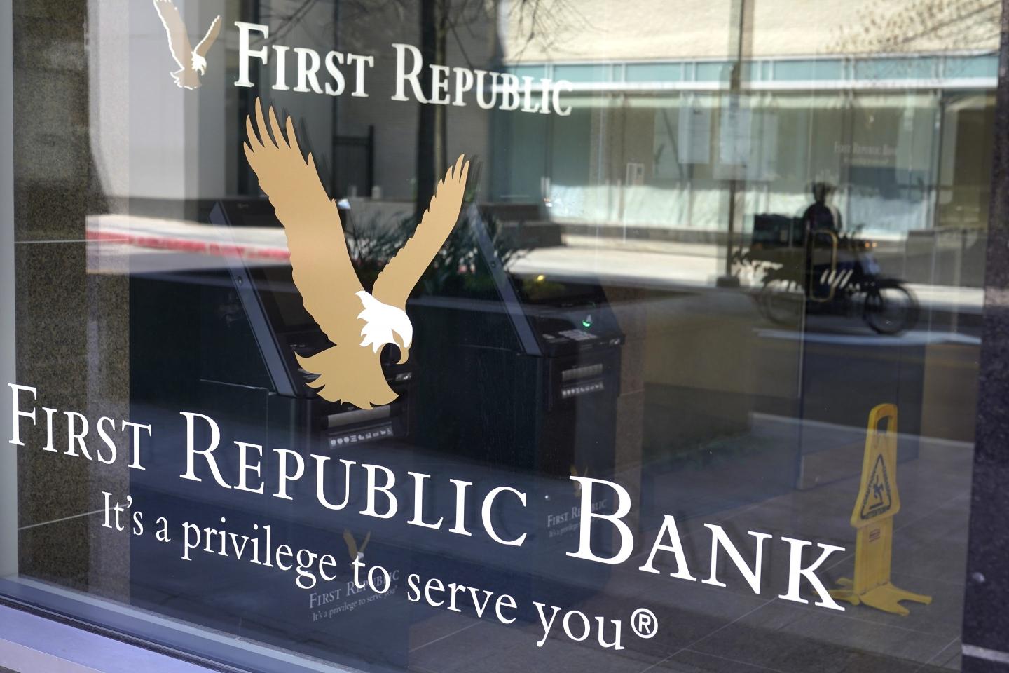 First Republic Bank signs and logos are attached to a window at a branch location, Wednesday, April 26, 2023, in Boston.