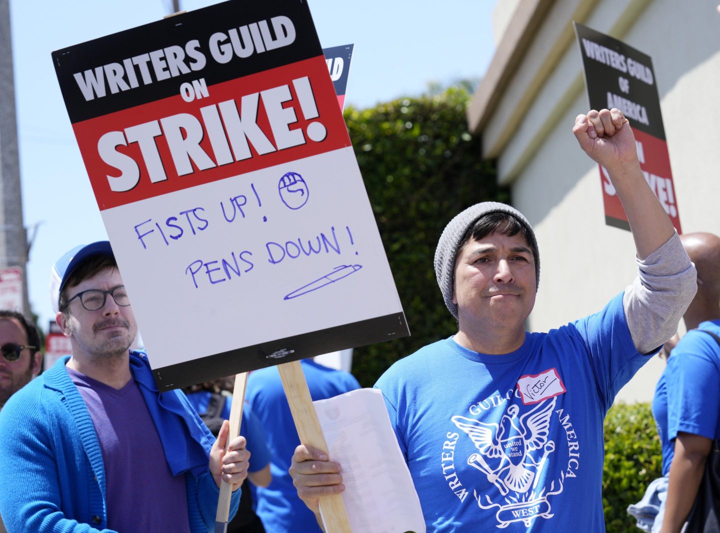Writers Guild of America West member Victor Duenas pickets with others at an entrance to Paramount Pictures, on May 2, 2023, in Los Angeles.