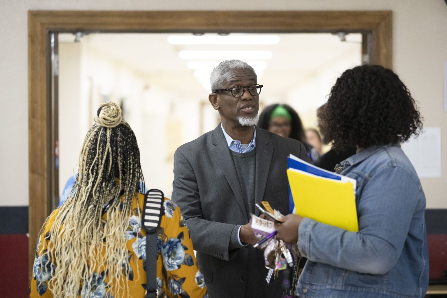 William Penn School District Superintendent Eric Becoats, center, speaks with prospective applicants during a teachers job fair at the high school's cafeteria in Lansdowne, Pa., on May 3, 2023.