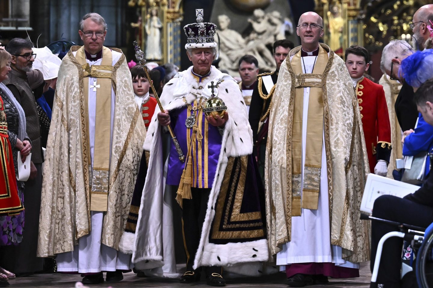 Britain's King Charles III wearing the Imperial state Crown and carrying the Sovereign's Orb and Sceptre leaves Westminster Abbey after coronation in central London Saturday, May 6, 2023.