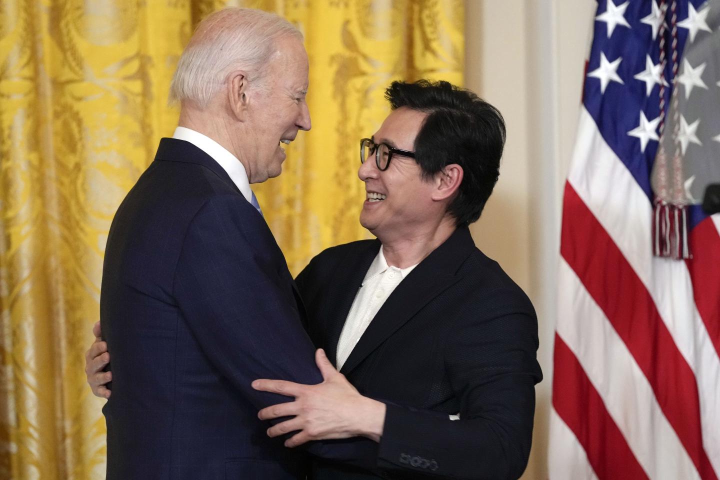 Actor Ke Huy Quan hugs President Joe Biden after he introduced Biden to speak before a screening of the series "American Born Chinese" in the East Room of the White House in Washington. 