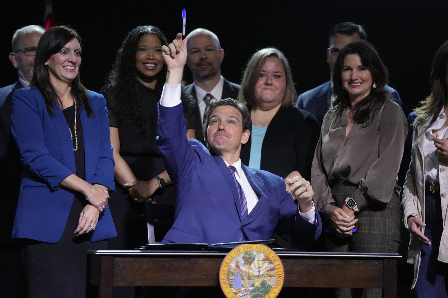 Florida Gov. Ron DeSantis throws a marker into the audience after signing various bills during a bill signing ceremony at the Coastal Community Church at Lighthouse Point, Tuesday, May 16, 2023, in Lighthouse Point, Fla.