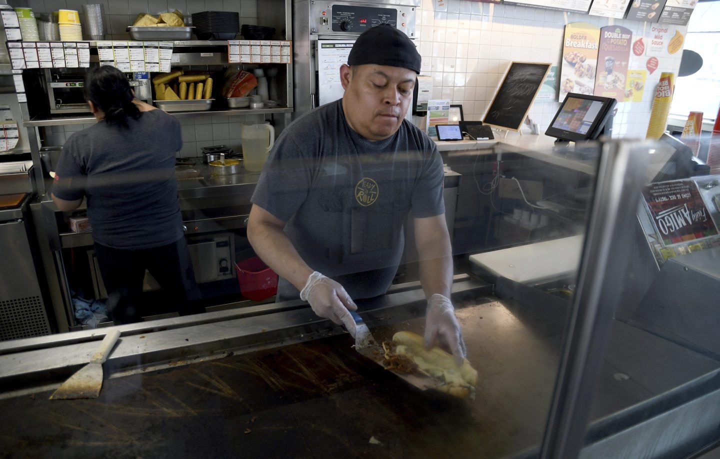 Ricardo Acosta prepares food at a Taco John&#8217;s restaurant in Denver on Tuesday, May 16, 2023. Taco Bell is asking U.S. regulators to force Wyoming-based Taco John&#8217;s to abandon its longstanding claim to the &#8220;Taco Tuesday&#8221; trademark. (AP Photo/Thomas Peipert)