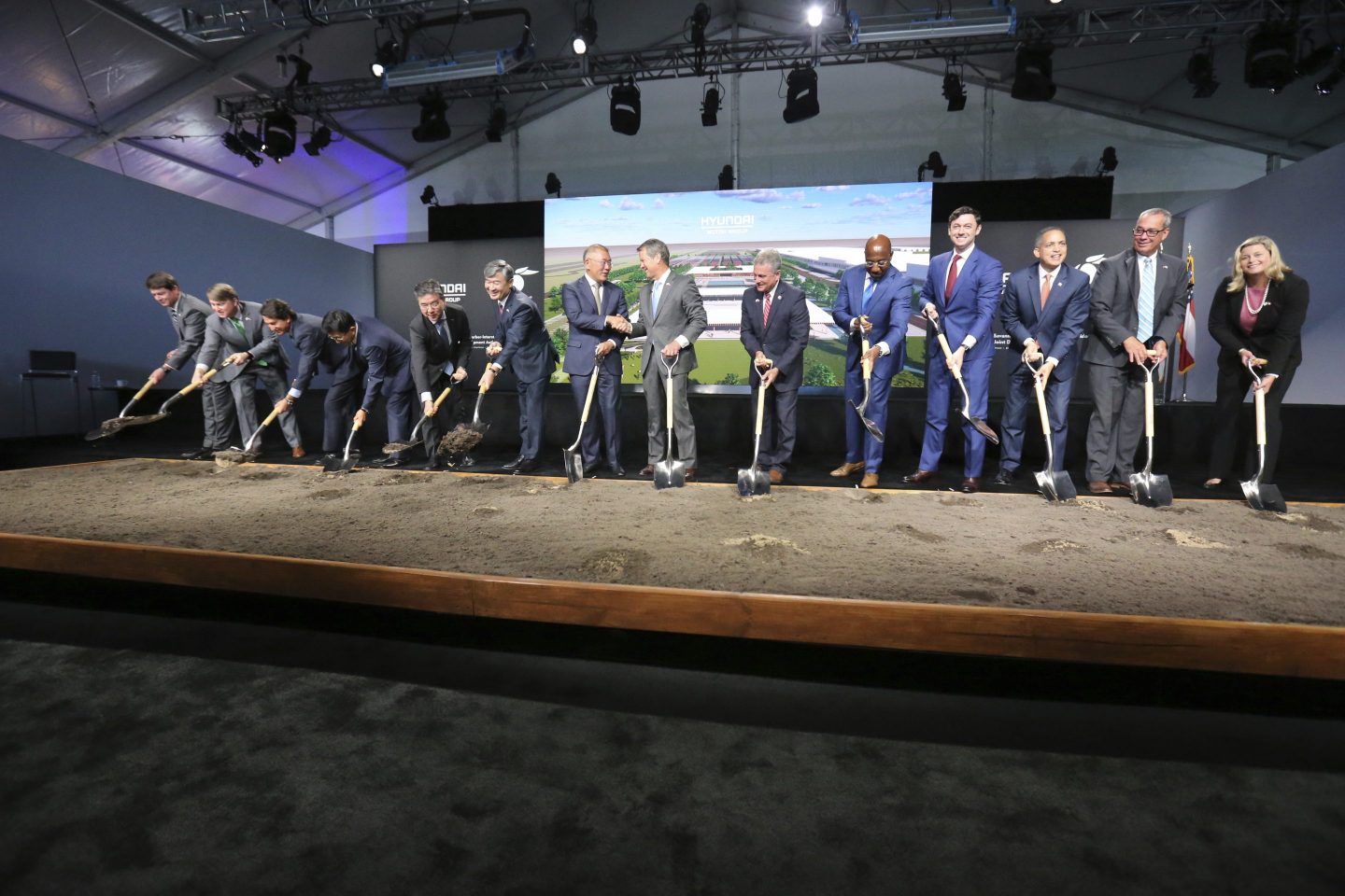 Chung Eui-sun, center left, executive chairman of Hyundai Motor Group, shakes hands with Georgia Gob. Brian Kemp as dignitaries join in for the official groundbreaking ing for the Hyundai Meta Plant, Oct. 25, 2022, in Ellabell, Ga.
