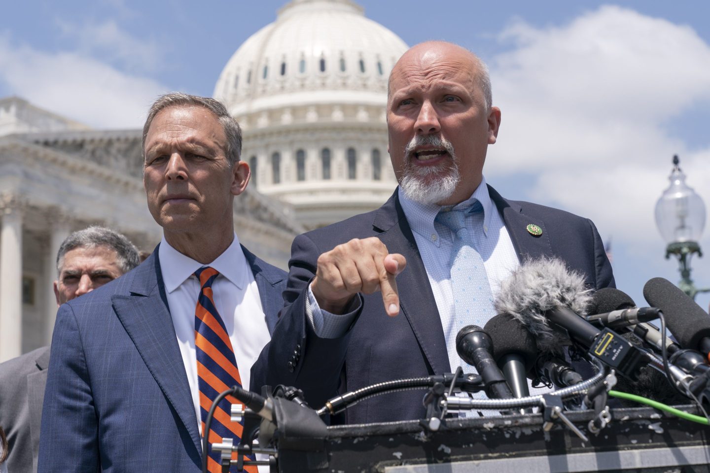 Rep. Scott Perry, R-Pa., left, and Rep. Chip Roy, R-Texas, speak with reporters as member of the conservative House Freedom Caucus talk about the debt limit deal, during a news conference, on May 30, 2023, on Capitol Hill in Washington.