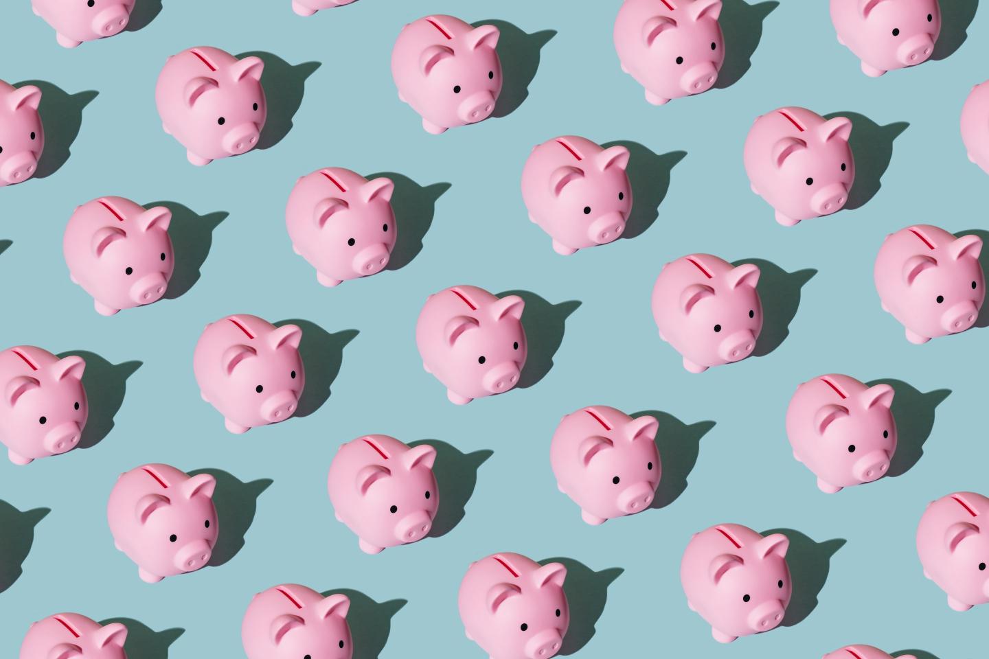 Pattern made of piggy bank on blue background