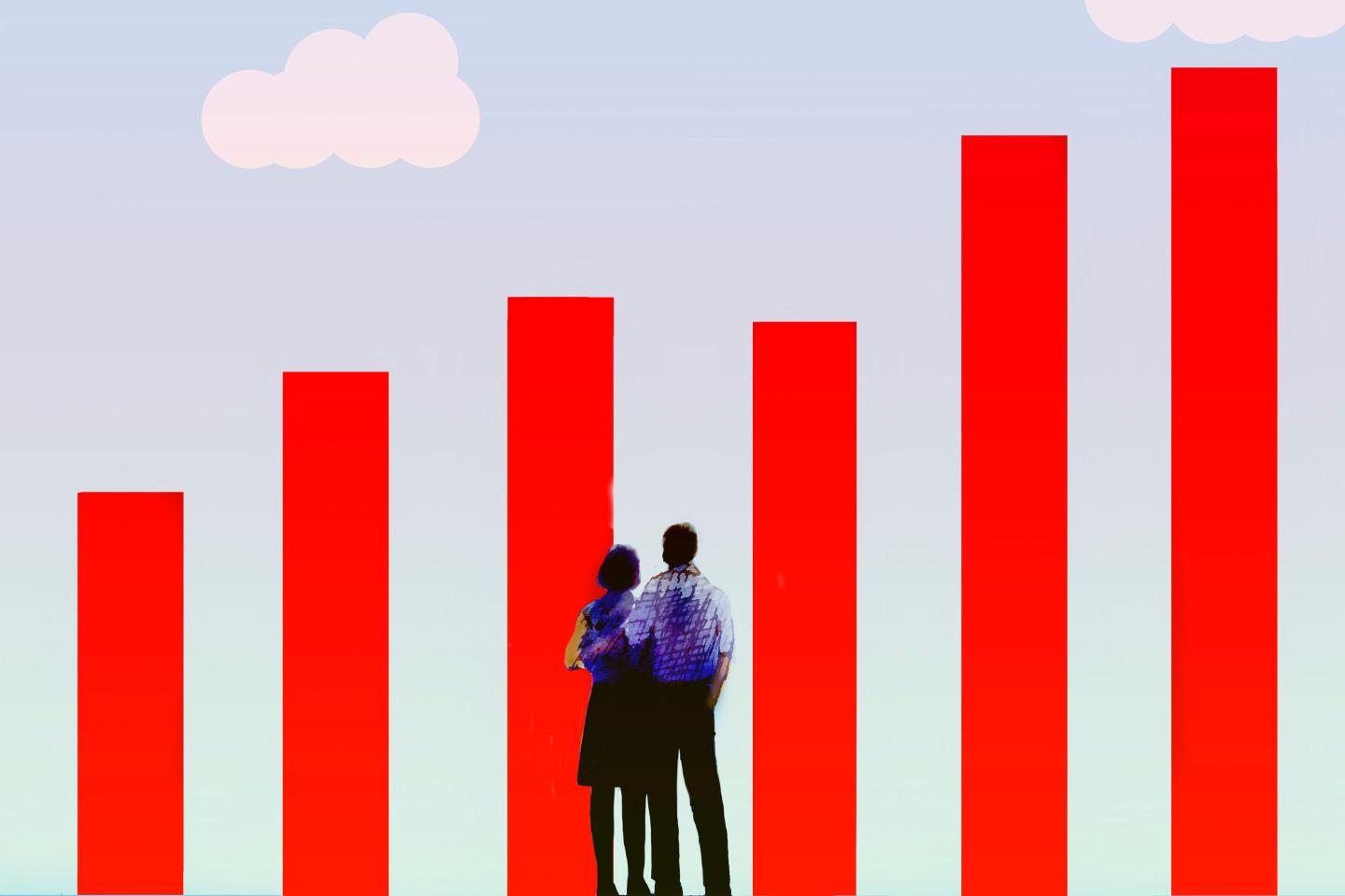 A couple stand looking at a growing bar chart
