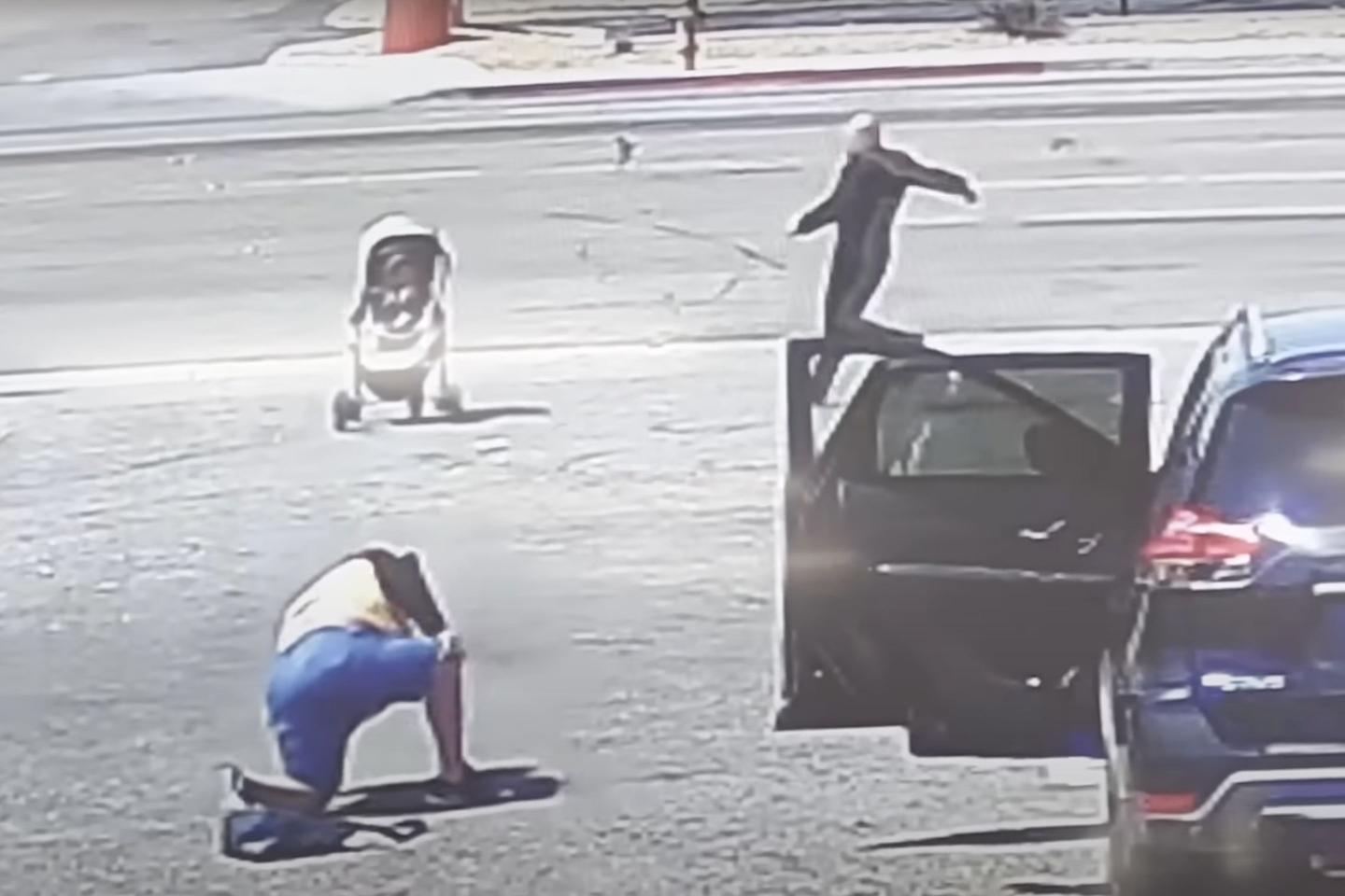 A screen shot from the moment Ron Nessman leaps into action to stop a stroller rolling into traffic.
