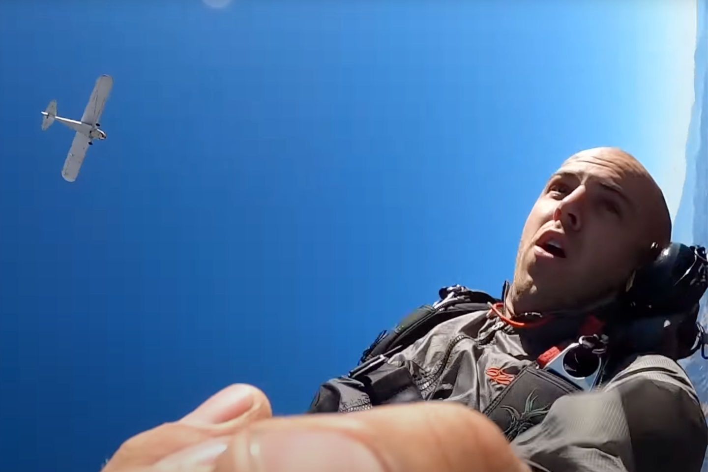 A screenshot from Trevor Jacob's YouTube video showing him parachuting out of his plane.