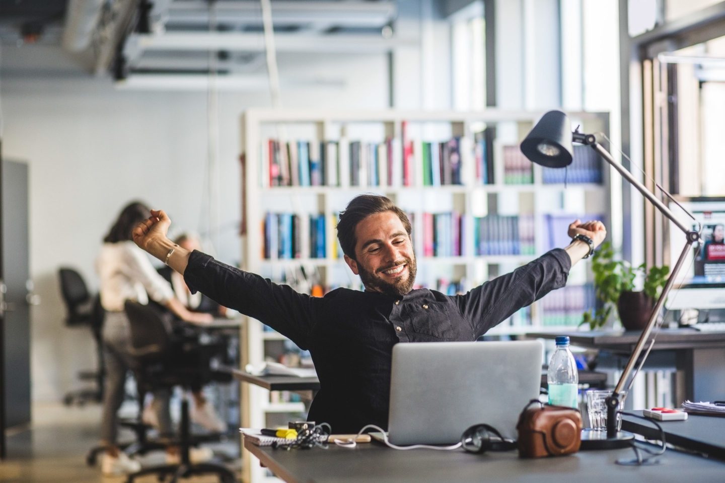happy workers at his desk