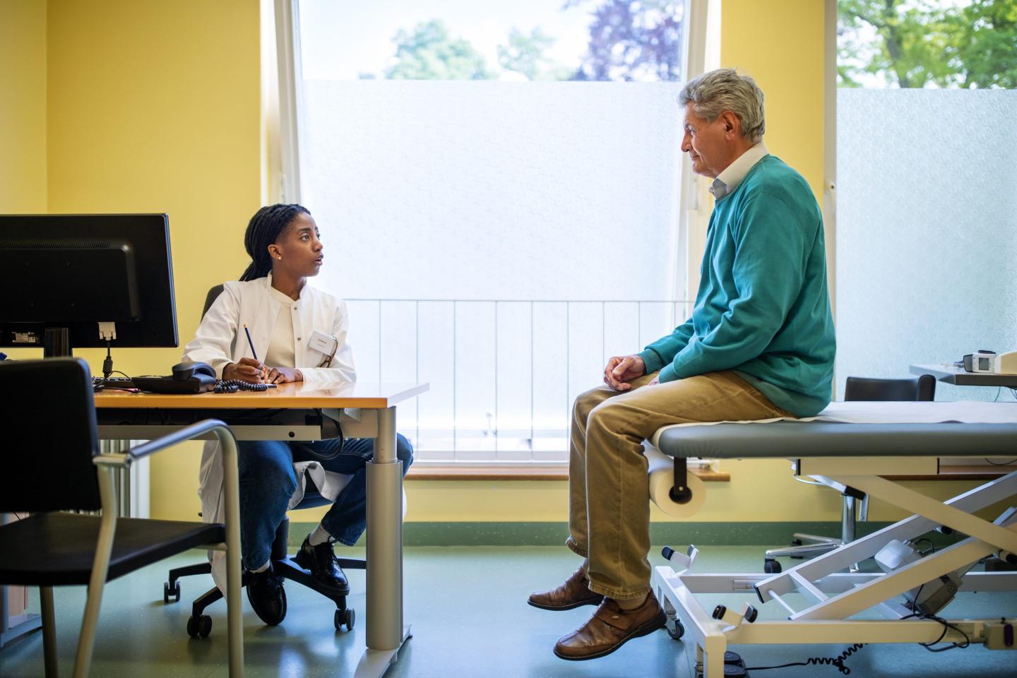 Female doctor talking with her patient in clinic