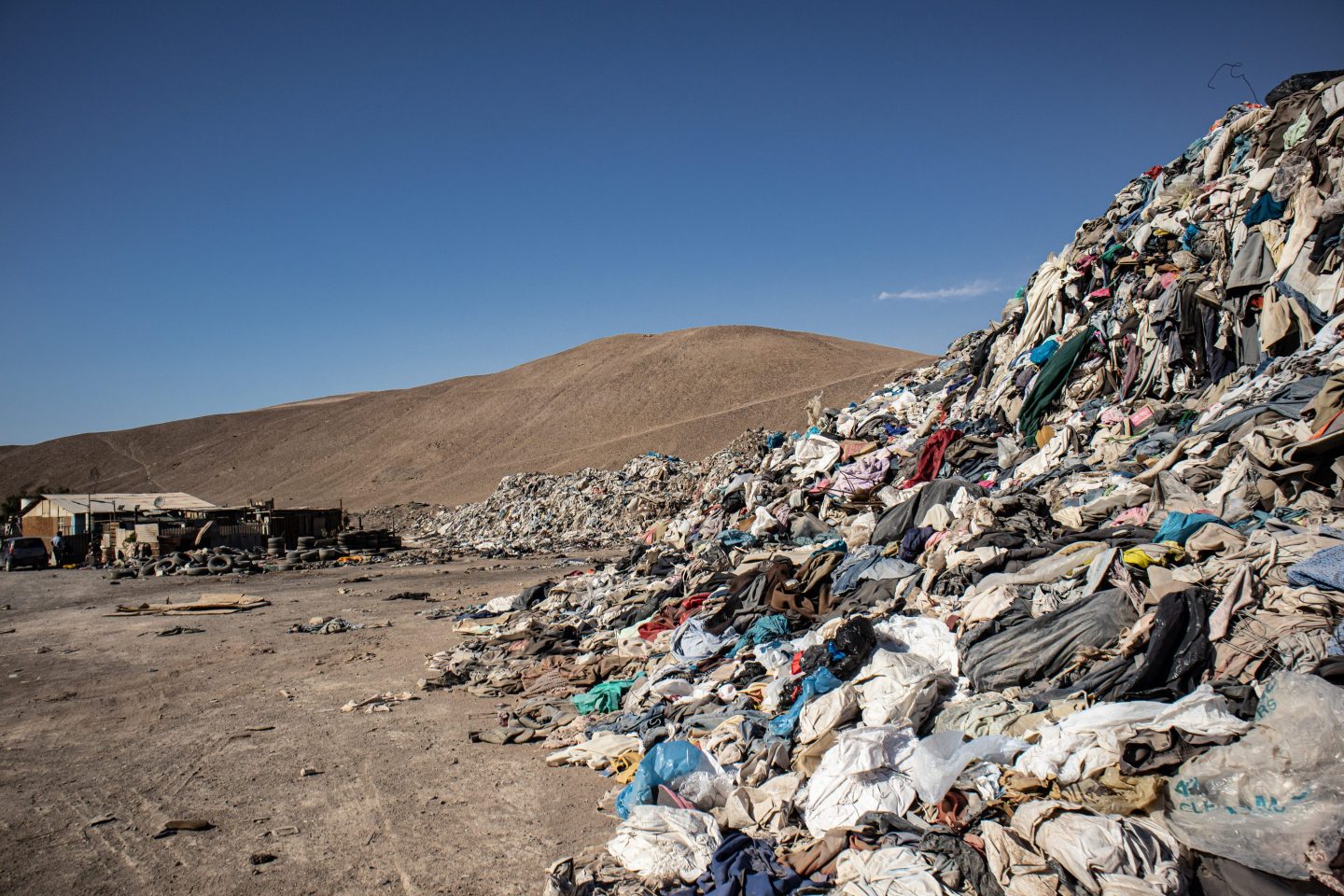 Used clothes sit in a landfill in the desert. In the nearby free trade zone of Iquique, 29,178 tons of used clothing arrived in 2021 through October.