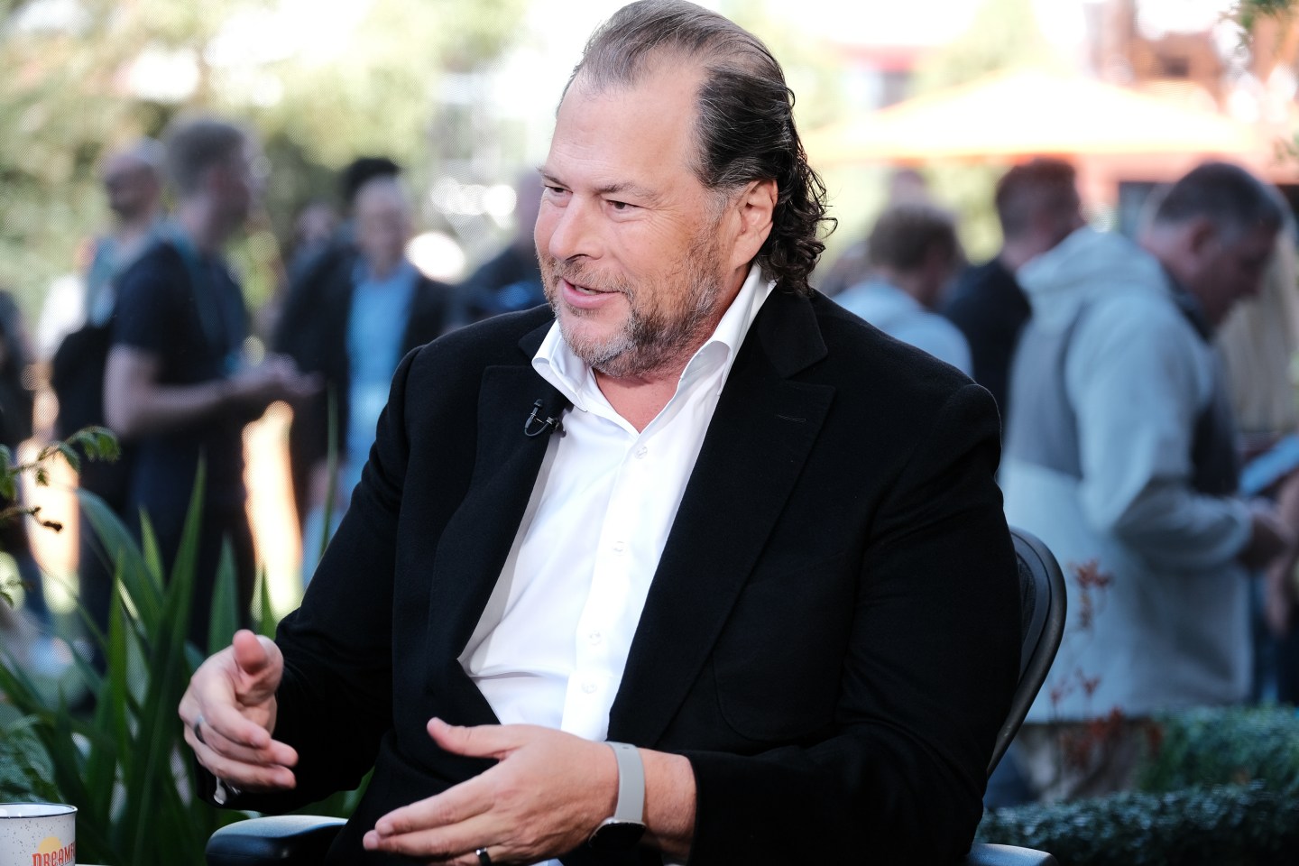 salesforce ceo marc benioff wearing a white collared shirt and black coat