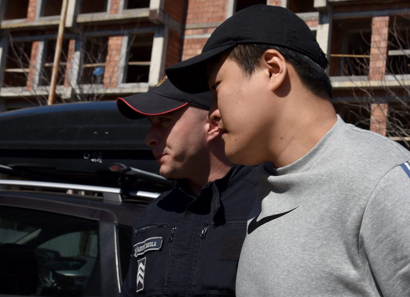 Police officers escort Do Kwon on March 24, 2023 in Podgorica, Montenegro. Cryptocurrency TerraUSD and its companion token Luna collapsed in 2022, wiping out approximately 40 billion USD from the cryptocurrency market and Do Kwon, the founder was charged with fraud by American prosecutors following his arrest in Montenegro.