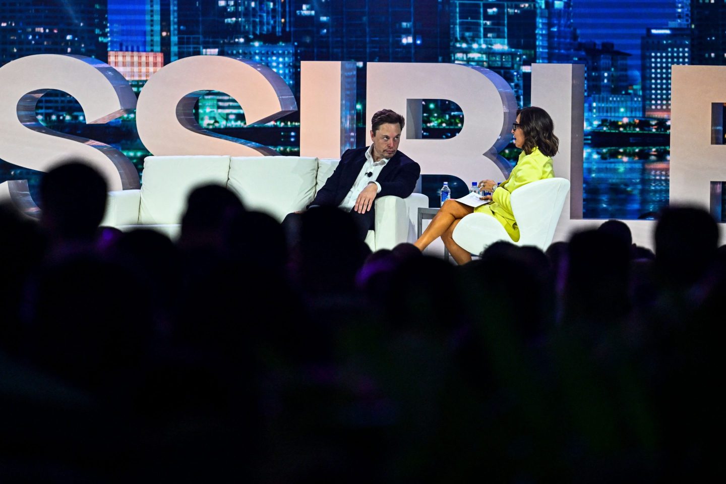 Twitter CEO Elon Musk speaks to NBCUniversal ad executive Linda Yaccarino at the "Twitter 2.0: From Conversations to Partnerships" marketing conference in Miami Beach, on April 18, 2023.