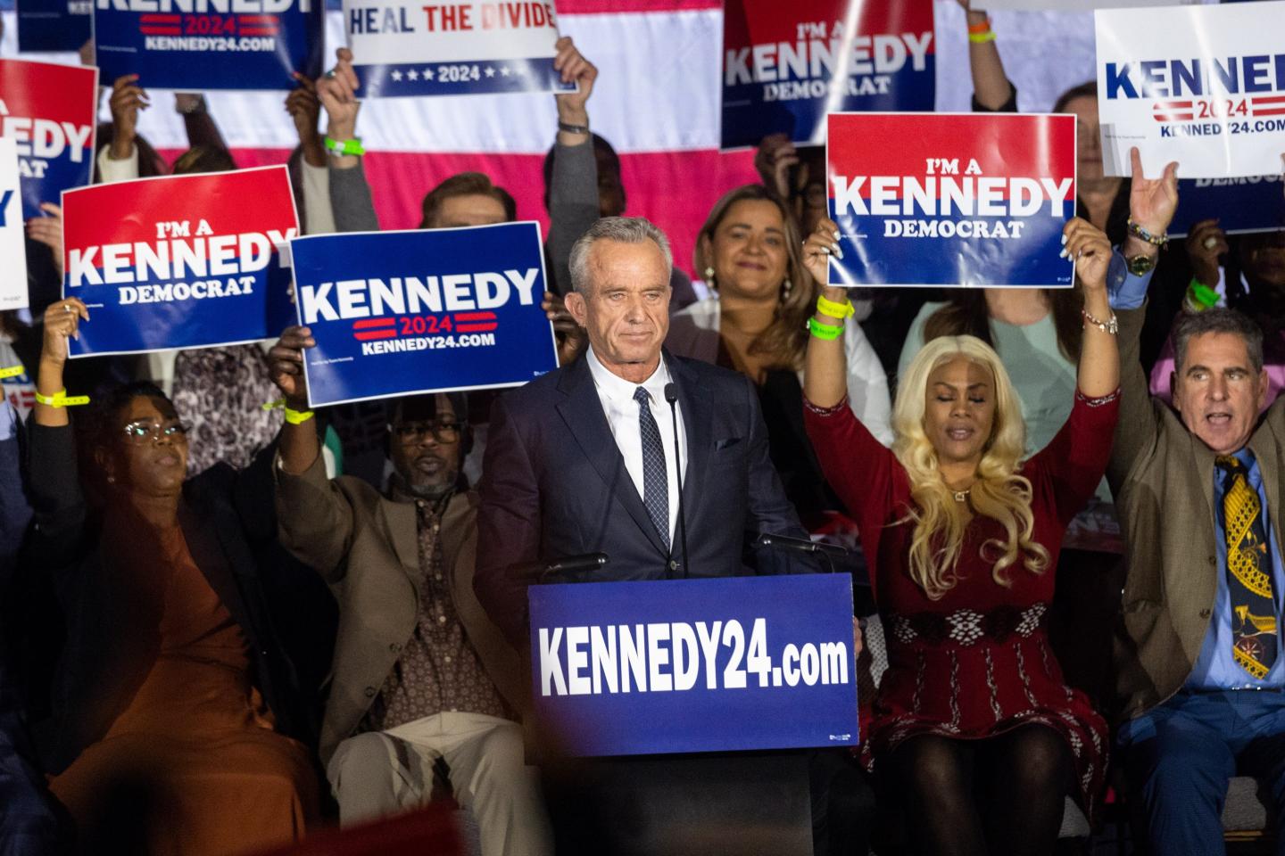 Robert F. Kennedy stands at the podium during a political rally.