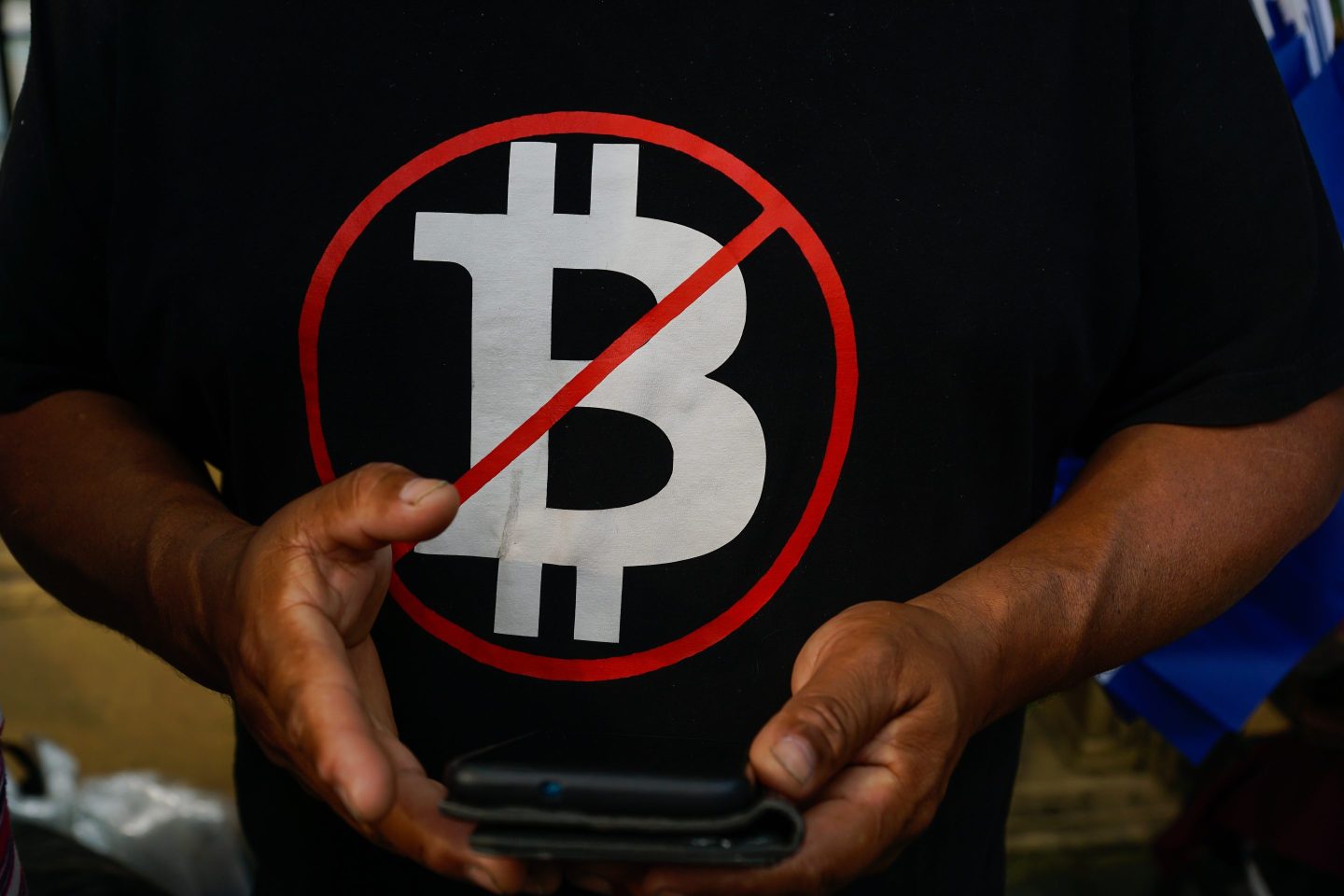 A man wears a shirt against the cryptocurrency "Bitcoin", during a protest against the government of Salvadoran President, Nayib Bukele, part of Labor Day, in San Salvador, El Salvador, on May 1, 2023.