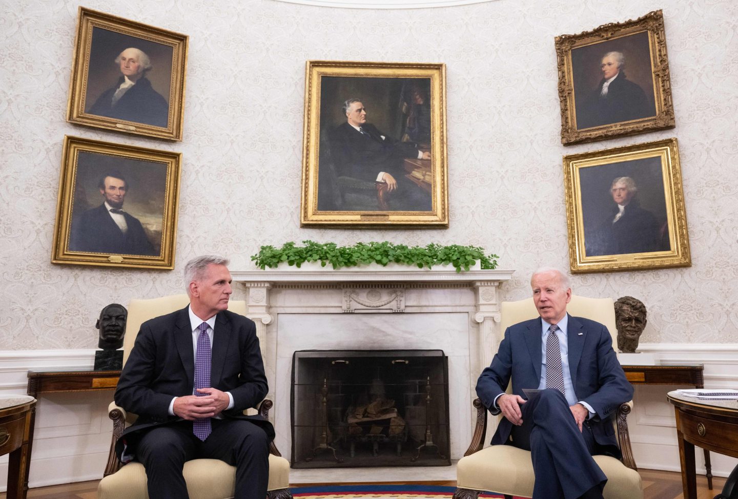 US House Speaker Kevin McCarthy (R-CA) (L) looks on as US President Joe Biden speaks during a meeting on the debt ceiling